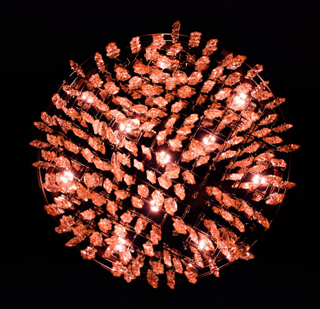 lighted red chandelier on a black background