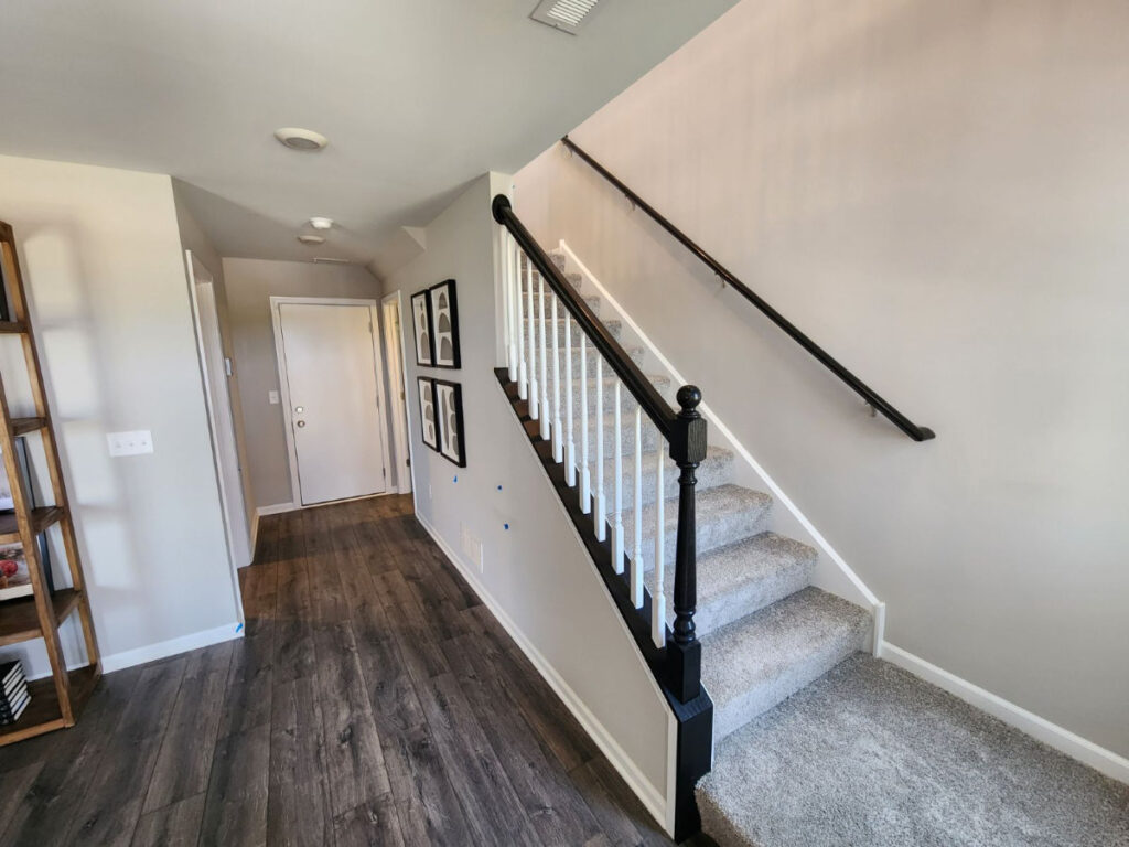 newly painted staircase with hardwood railings