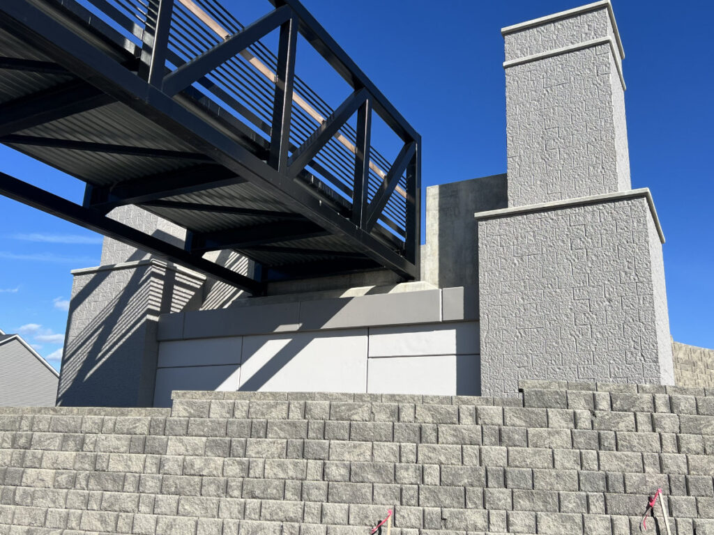 painted steel and concrete walking overpass